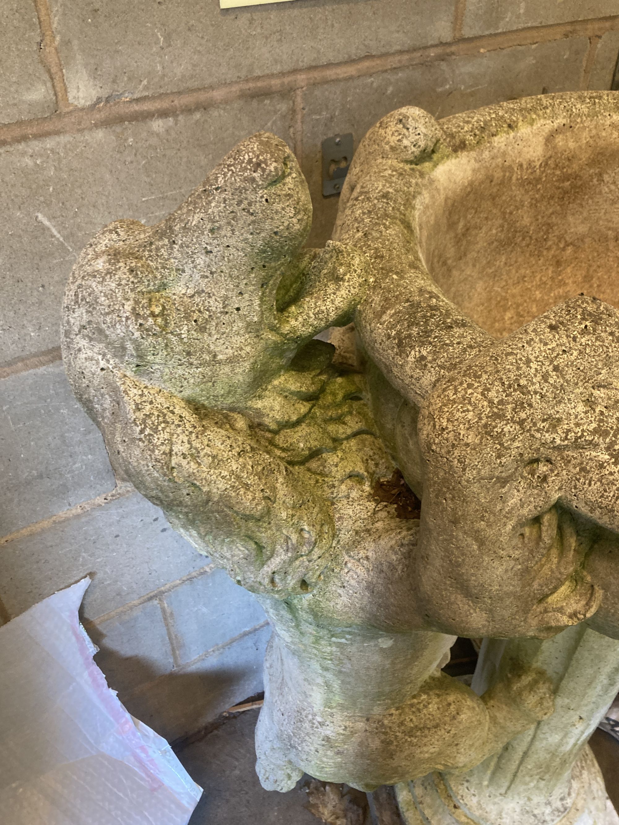 A reconstituted stone garden fountain modelled as a hound drinking from a circular bowl, width 80cm height 112cm